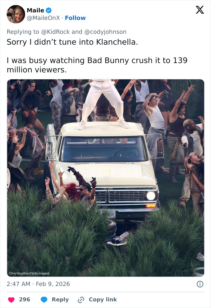 Kid Rock stands on a vehicle surrounded by dancers during an alternative halftime show performance.