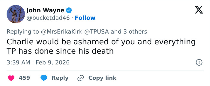 Tweet from John Wayne replying to Erika Kirk about Turning Point USA&rsquo;s alternate halftime show controversy.