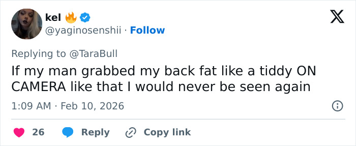 Twitter reply from user kel reacting to a viral low-cut dress advertisement with a humorous personal comment.