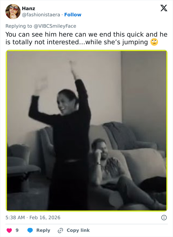 Prince Harry sitting with uninterested body language while Meghan Markle joyfully raises arms indoors. Prince Harry sitting with uninterested body language while Meghan Markle joyfully raises arms indoors.