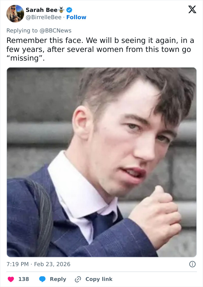 Young man in a suit with tousled hair, captured outdoors, linked to karma and students involved in fireworks incident.