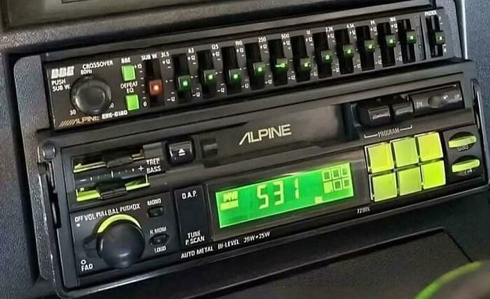 Vintage Alpine car stereo with green digital display and classic control buttons representing nostalgic pics and references.
