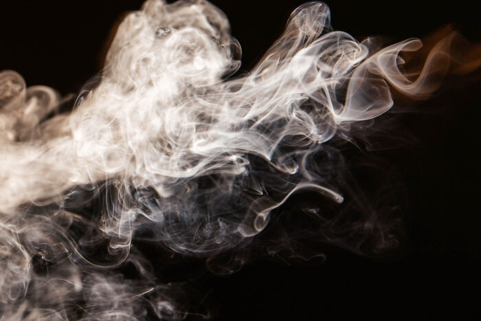 Wisps of white smoke swirling against a dark background symbolizing brutal wake-up calls and escape from nasty situations.
