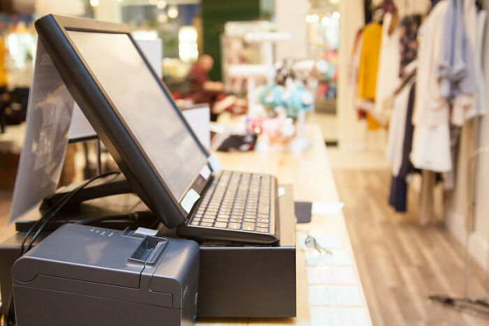 Point of sale system and receipt printer on a counter in a retail store setting during a graveyard shift.