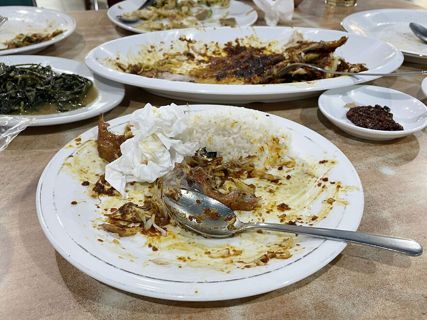 Messy plates with leftover food and used napkins on a table showcasing common pet peeves that divide a room.