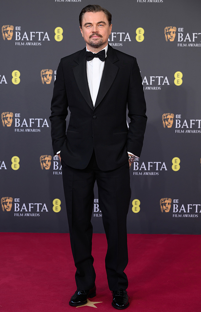 Actor wearing a classic black tuxedo and bow tie on the red carpet at the most talked-about BAFTA 2026 outfits event.