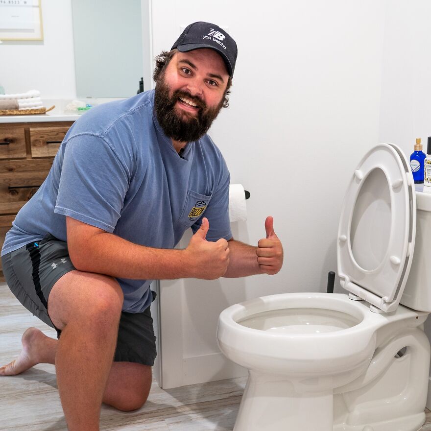 Man giving thumbs up next to a clean toilet, illustrating common pet peeves that instantly divide a room.