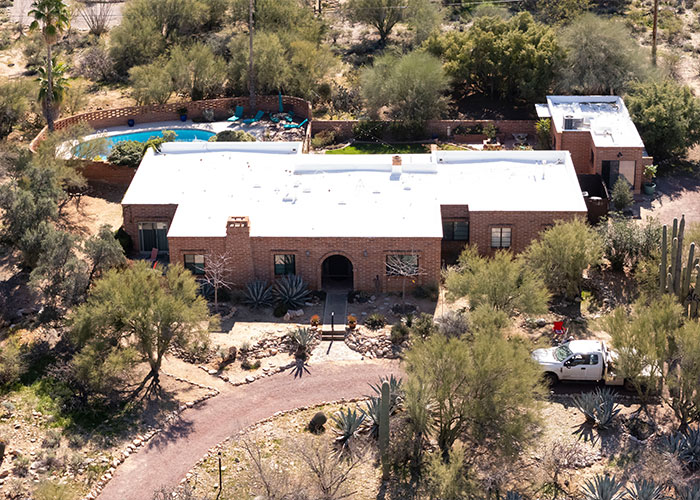 Aerial view of a desert home surrounded by trees and shrubs related to Nancy Guthrie disappearance investigation.