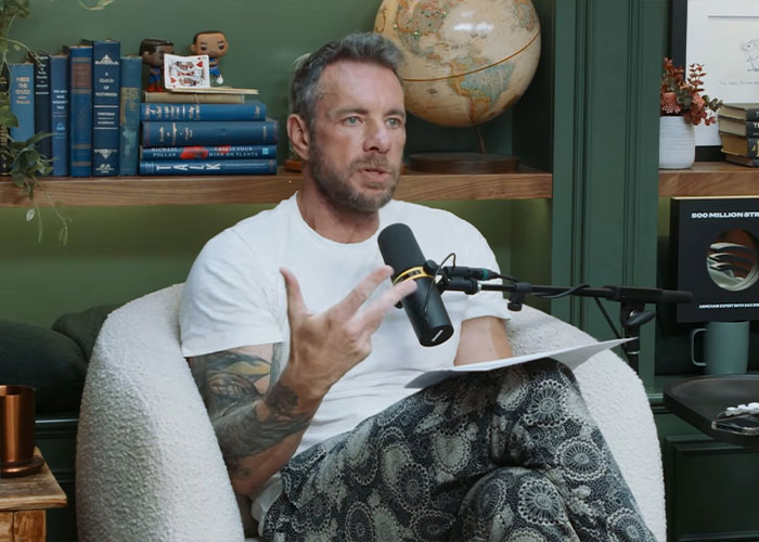 Dax Shepard speaking into a microphone during a podcast episode discussing why he&rsquo;s not a fan of Kristen Bell.