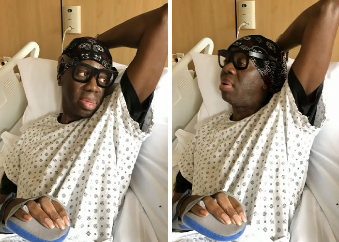 ANTM star J Alexander in hospital gown resting in bed during recovery after experiencing a stroke.