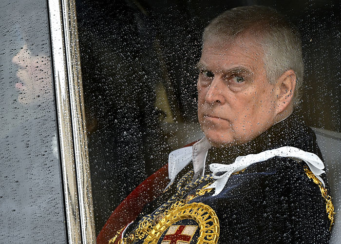 Prince Andrew in ceremonial uniform, sitting behind a rain-speckled window, highlighting the royal expert's arrest concerns. Prince Andrew in ceremonial uniform, sitting behind a rain-speckled window, highlighting the royal expert's arrest concerns.