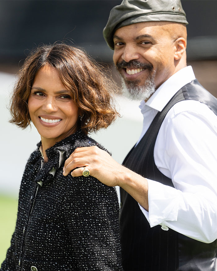 Halle Berry smiling outdoors with a man wearing a hat, highlighting Halle Berry intimacy refusal topic.