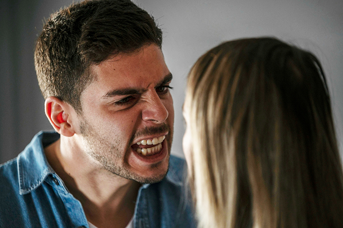 Angry young man confronting a woman indoors, illustrating family chaos after one DNA test reveals shocking truth.