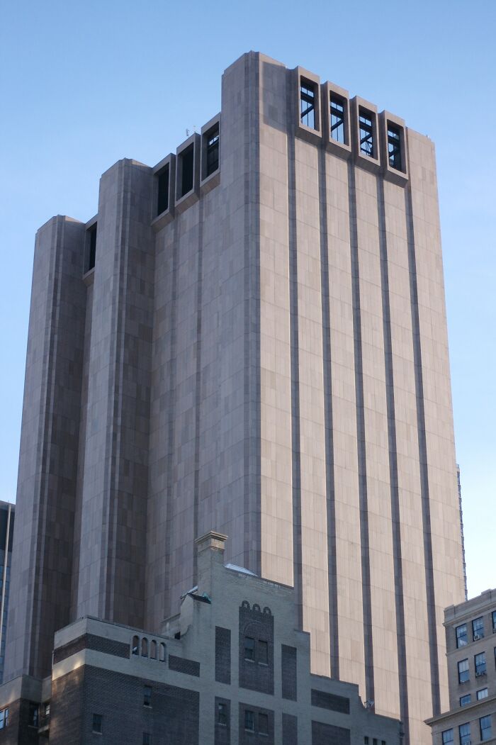 Unique unusual building with a towering facade in an urban area, one of the unusual places around the world.