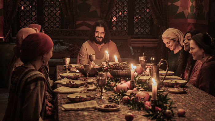 Scene from The Chosen featuring a group gathered around a candlelit table, highlighting The Chosen Season 6 update.