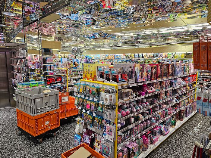 Toy store aisle filled with various toys and collectibles, showing a common retail setup in many countries.