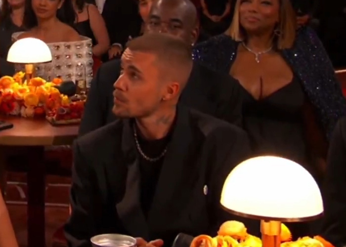 Man with a serious expression in a dark suit at an event, body language expert decodes tense behavior. Man with a serious expression in a dark suit at an event, body language expert decodes tense behavior.