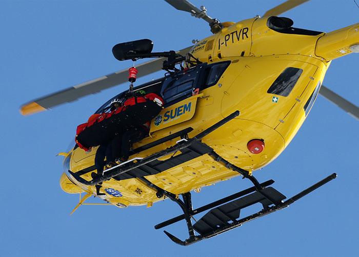 Rescue team performing aerial evacuation in a yellow helicopter relating to Lindsey Vonn’s ICU stay after Winter Olympics crash.