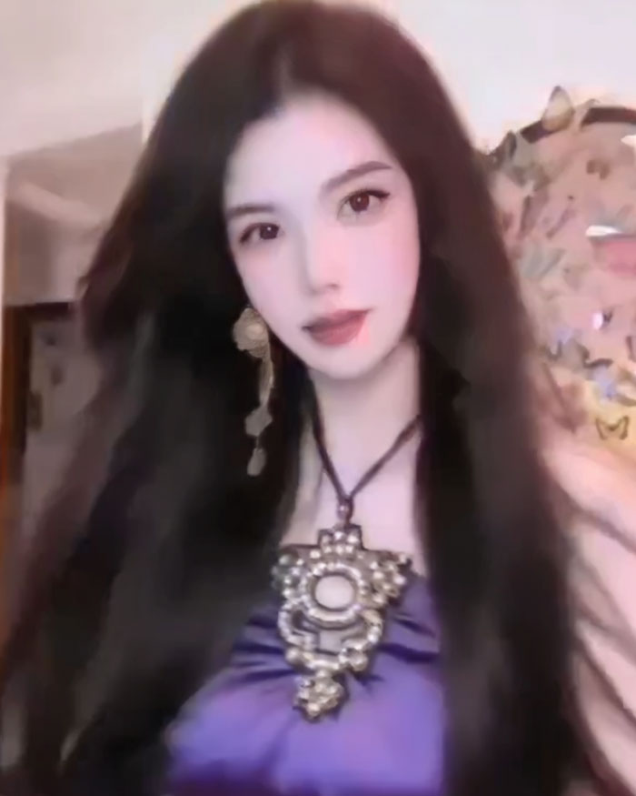 Beauty influencer with long dark hair wearing a purple top and large pendant, representing filter fail and lost followers story.