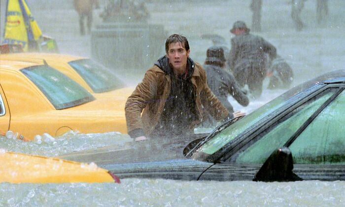 Man standing in flooded street with yellow taxis and cars, witnessing strange things that made him question everything.