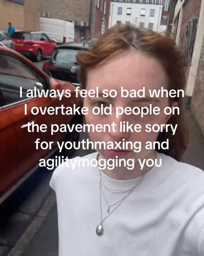 Woman walking on a street with a cynical meme about feeling bad for youthmaxing and agilitymogging older people on pavement.