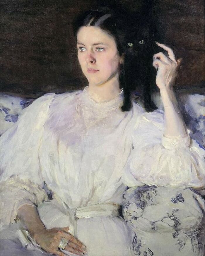 Woman in vintage white dress sitting with a black cat on her shoulder in a classic cat-themed artwork painting.