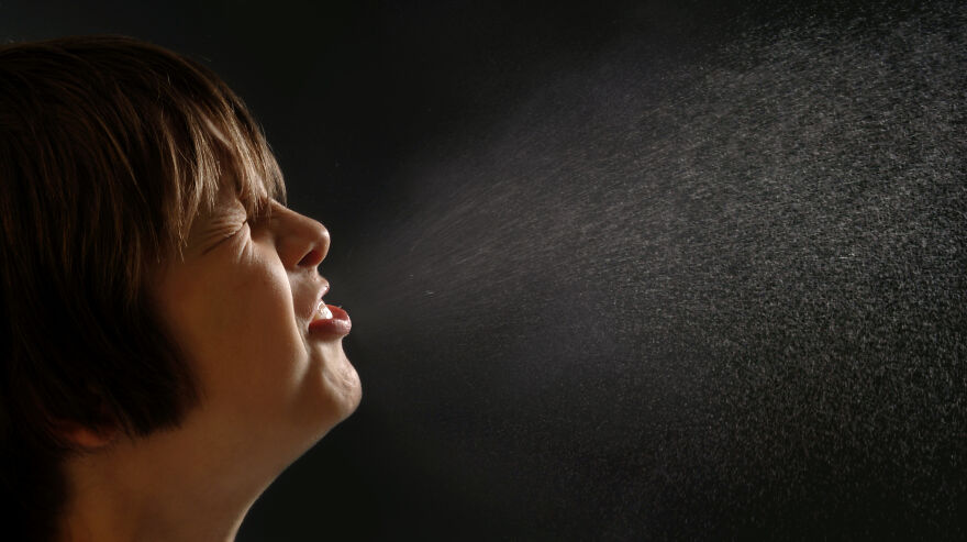 Child sneezing with visible droplets in the air, illustrating common pet peeves that instantly divide a room.