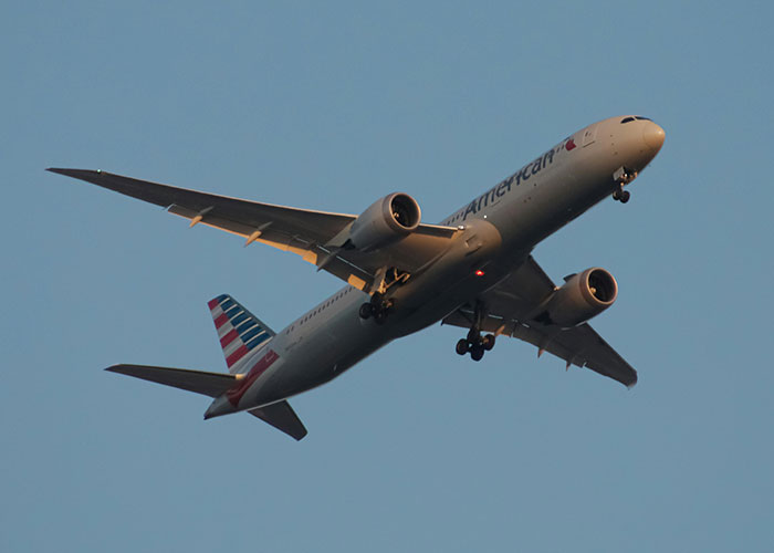 Airplane flying in clear sky illustrating travel encounter involving a woman and kind stranger on a plane.