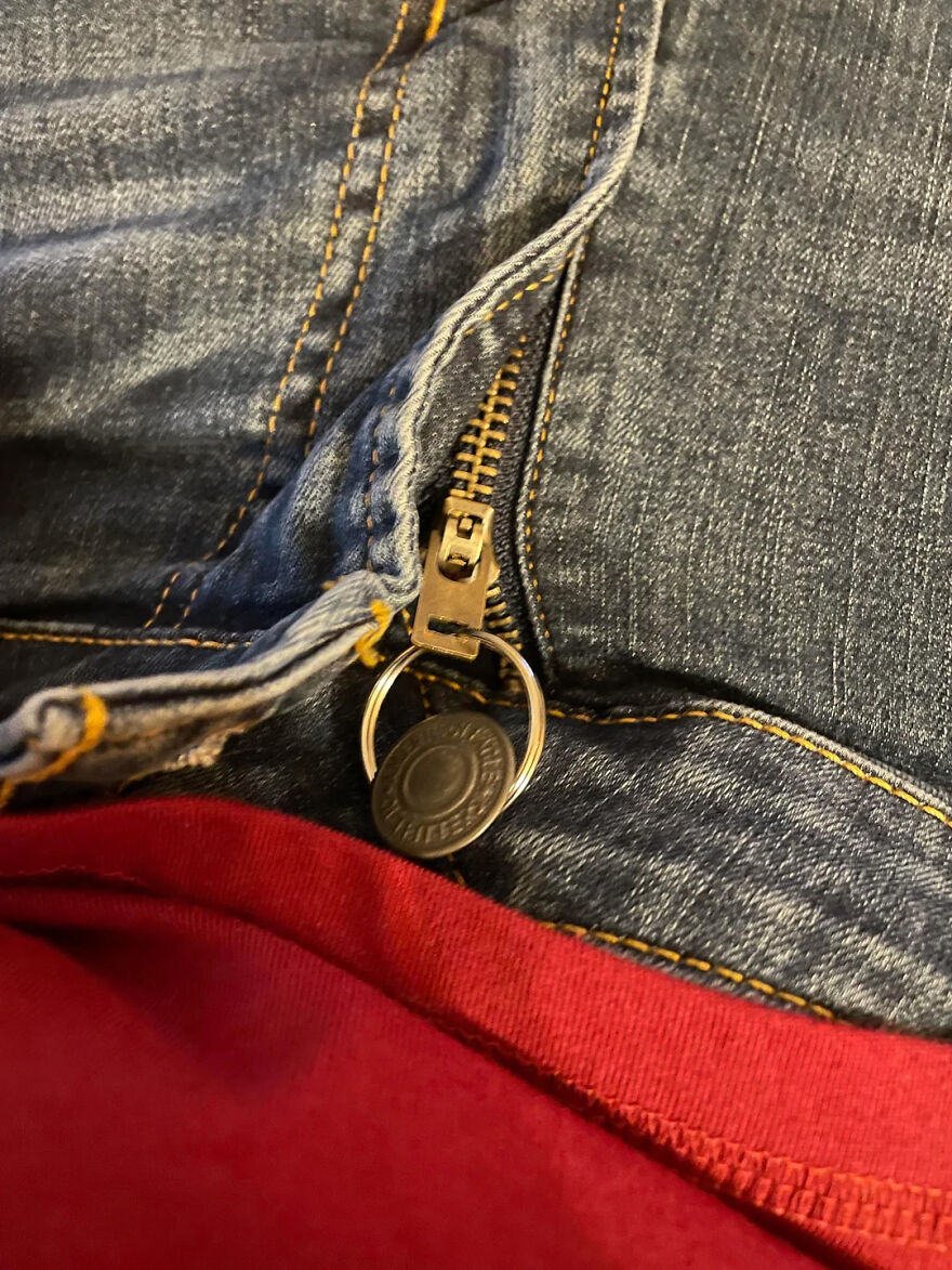 Jeans zipper repaired using a key ring as a simple everyday item hack for easy zipper fixing.