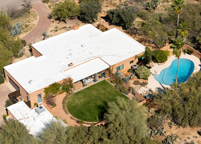 Aerial view of a desert home with a pool and garden, related to FBI official insights on Nancy Guthrie disappearance.