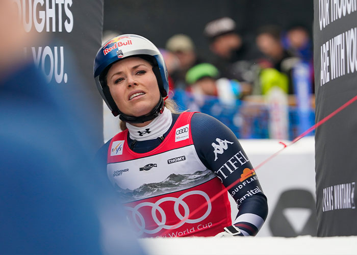 Lindsey Vonn in skiing gear and helmet after Winter Olympics crash, related to ICU stay and terrifying details.