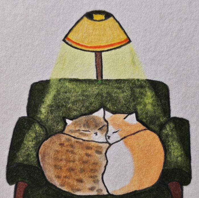 Two cats curled up asleep on a green armchair under a yellow lamp, cat-themed artwork showing cozy comfort.