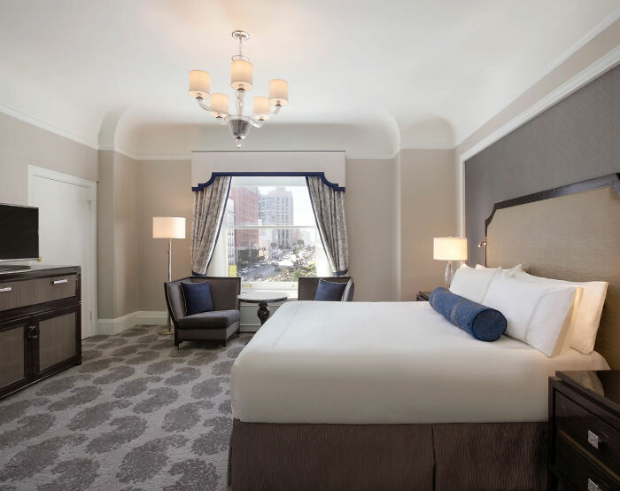 Luxury hotel room with king bed and city view, related to Tommy Lee Jones&rsquo; daughter&rsquo;s cause of passing revealed after found.