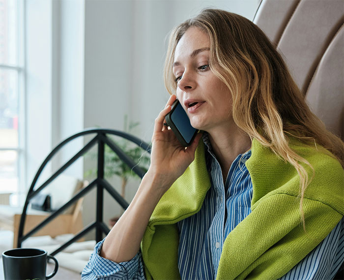 Woman talking on phone at home, reacting to family moving in and the real reason behind it revealed.
