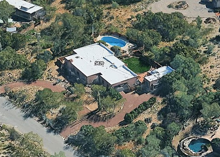 Aerial view of a secluded Arizona home surrounded by trees, relevant to police theory in Savannah Guthrie's mom case.