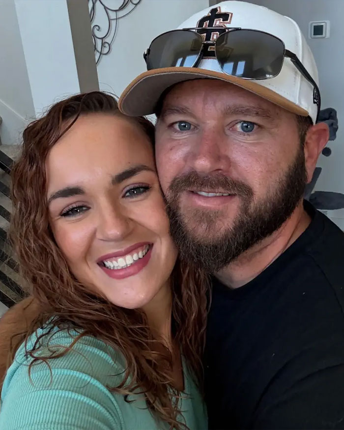 Smiling couple posing closely indoors, illustrating Utah dance mom&rsquo;s mean texts and parent clash related to Vegas tragedy.