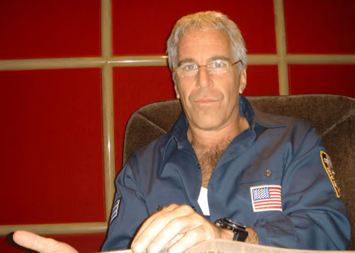 Man with gray hair and glasses in a blue shirt discussing royal expert views on Prince Andrew and King Charles impact. Man with gray hair and glasses in a blue shirt discussing royal expert views on Prince Andrew and King Charles impact.