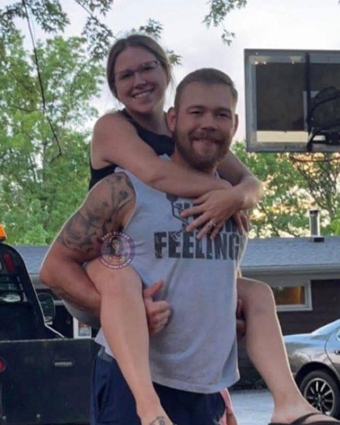 School employee smiling with husband outdoors, unrelated to disturbing act or confession video keywords.