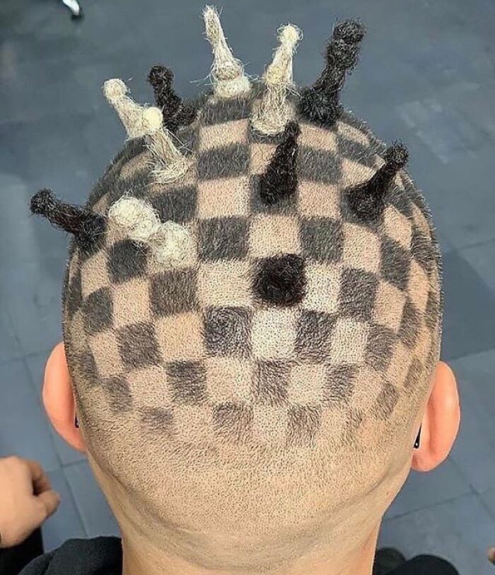 Checkerboard pattern and small hair twists create a weirdly hilarious hairstyle on a shaved head.