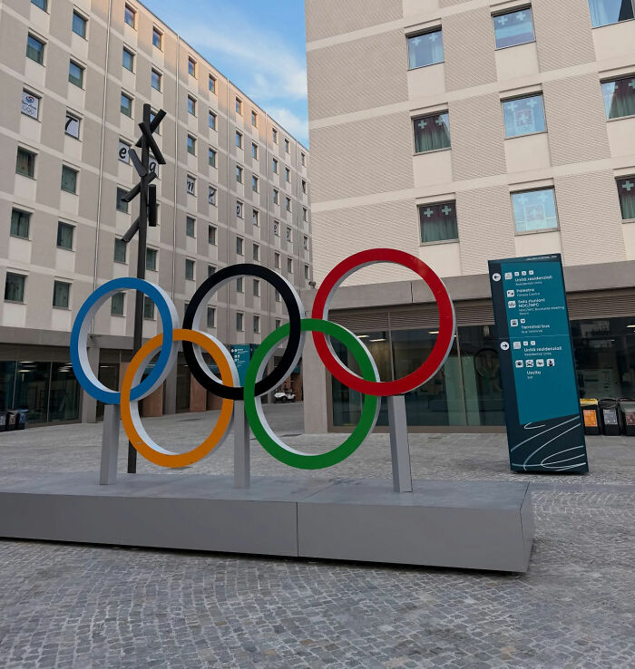 Olympic rings sculpture in residential area representing Winter Olympics Milan rooms after Paris' viral bed issues.