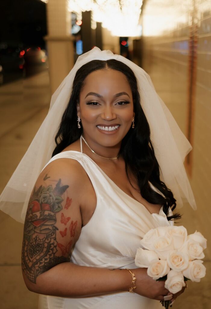 Smiling bride in wedding dress holding bouquet, showcasing confidence and respect in a committed relationship.