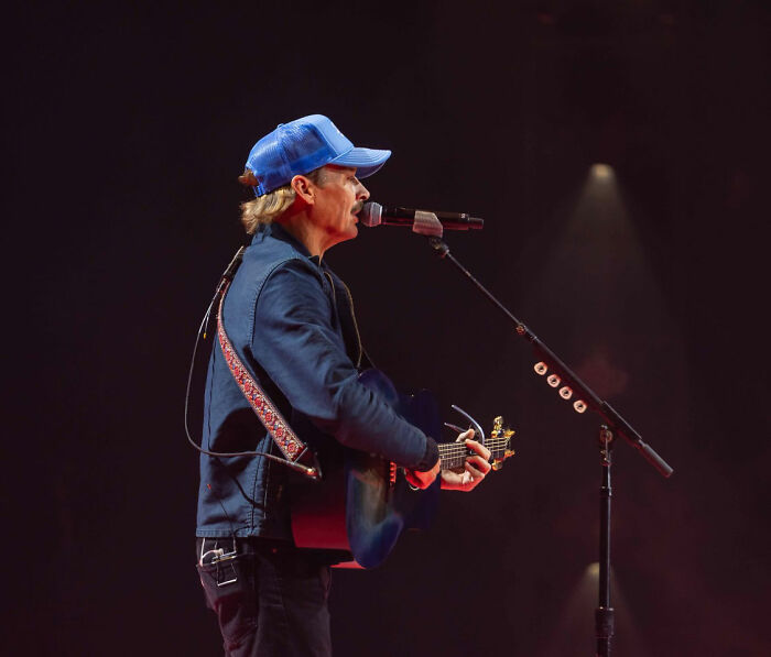 Kid Rock performing on stage with guitar and microphone during alternative halftime show after being mercilessly mocked.