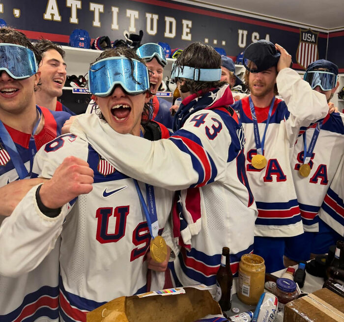 Team USA men's hockey players celebrating with gold medals and wearing goggles, sparking controversy after White House visit. Team USA men's hockey players celebrating with gold medals and wearing goggles, sparking controversy after White House visit.