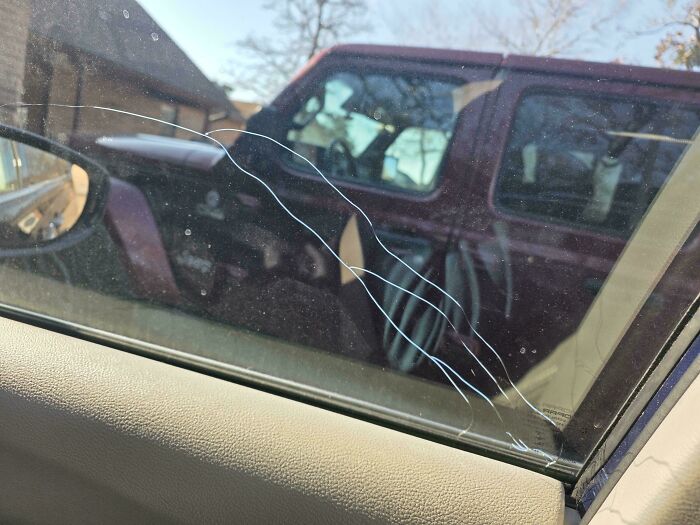 A car window with multiple long cracks, showing a challenge that a great dad might face.