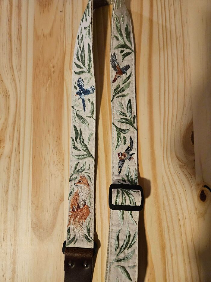 Stunning embroidery creations featuring a detailed fox and various birds on a strap, inspiring embroidery hobby.