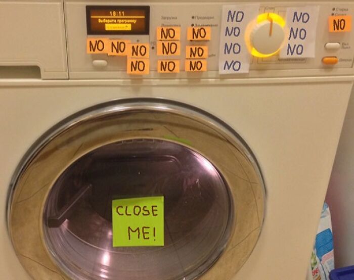 Front-loading washing machine covered in sticky notes with humorous parent notes saying no and close me.