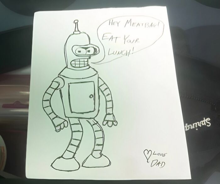 Hand-drawn robot note from dad saying eat your lunch, a creative and amusing note left by parents.