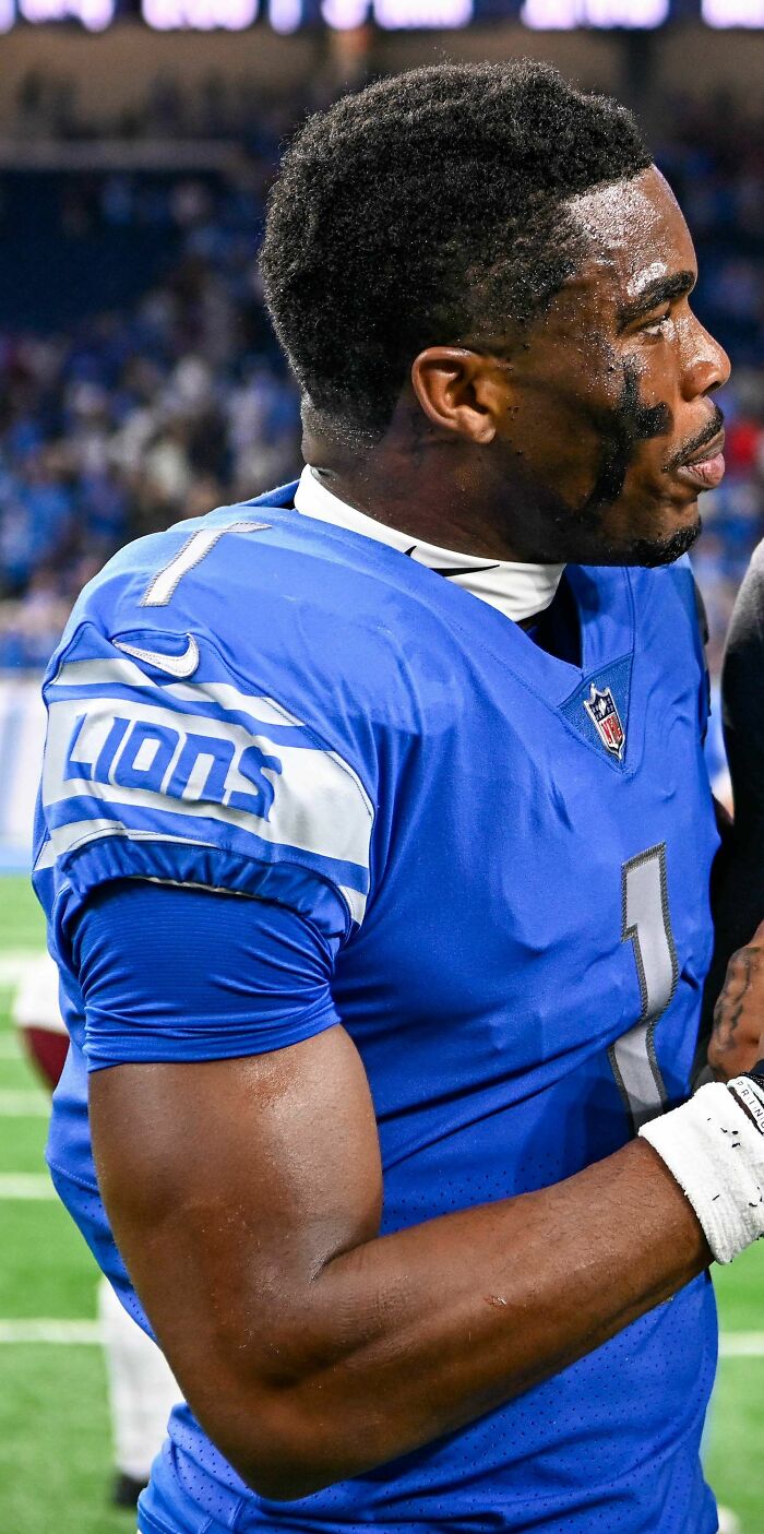 Jeff Okudah in Detroit Lions uniform on field, showing focus and determination during a game.