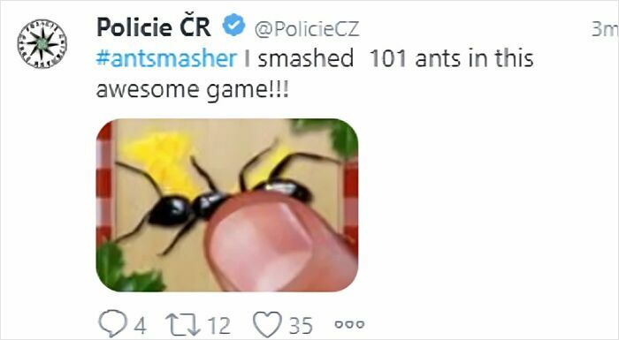 Tweet from a police social media account humorously sharing progress in an ants smashing game with a close-up image of a finger on ants.