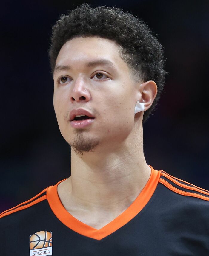 Isaiah Roby in basketball gear focused during a game, highlighting key moments in his bio and career.